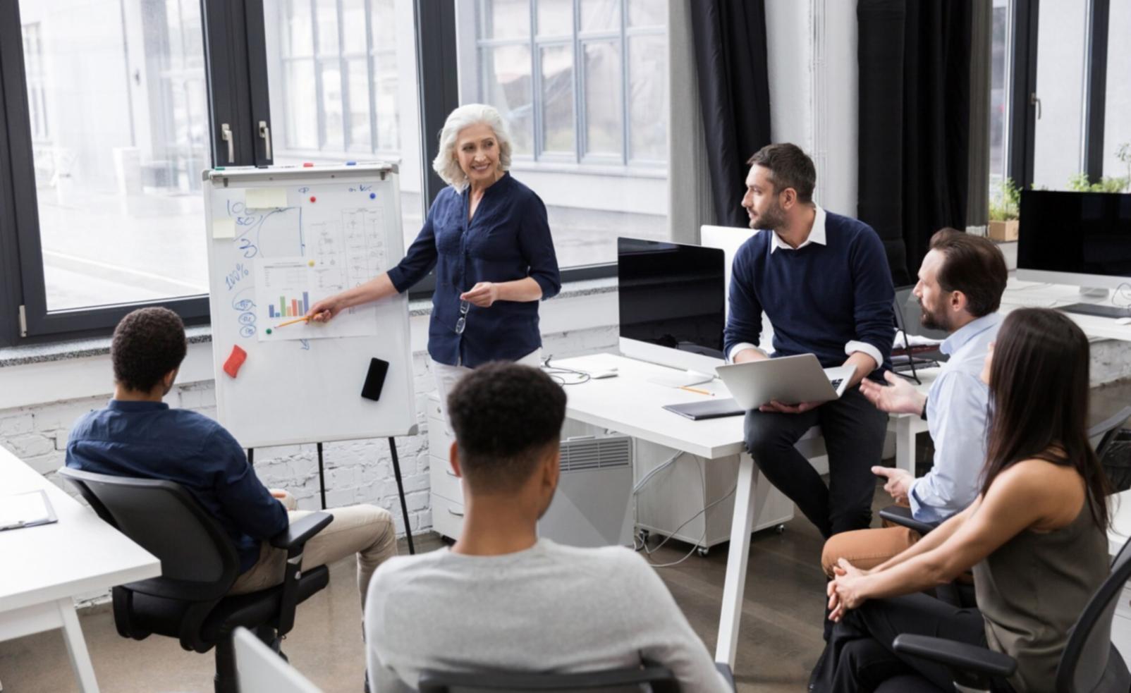 Modern office environment with finance professionals working on investment analysis projects